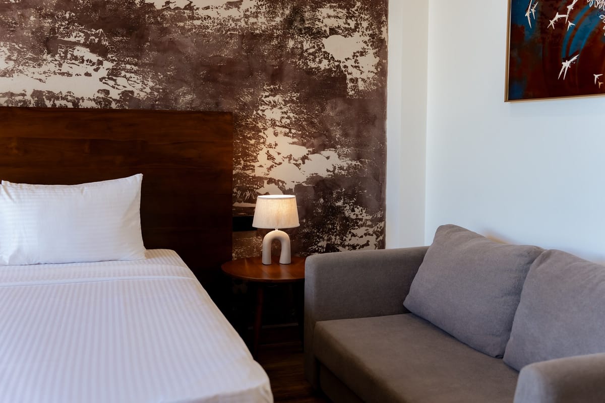 River View Room 2, sofa and wooden headboard