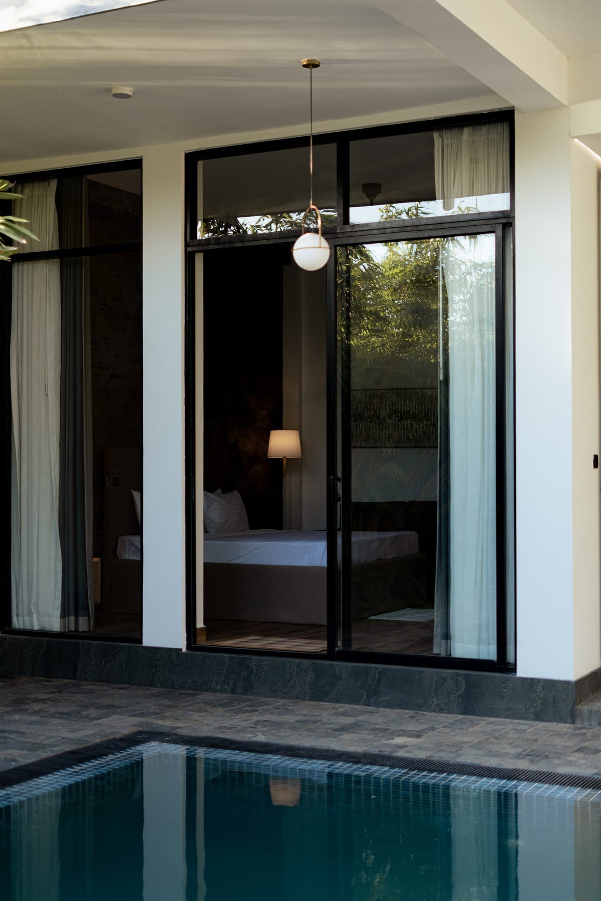 The picture windows of the garden-level rooms